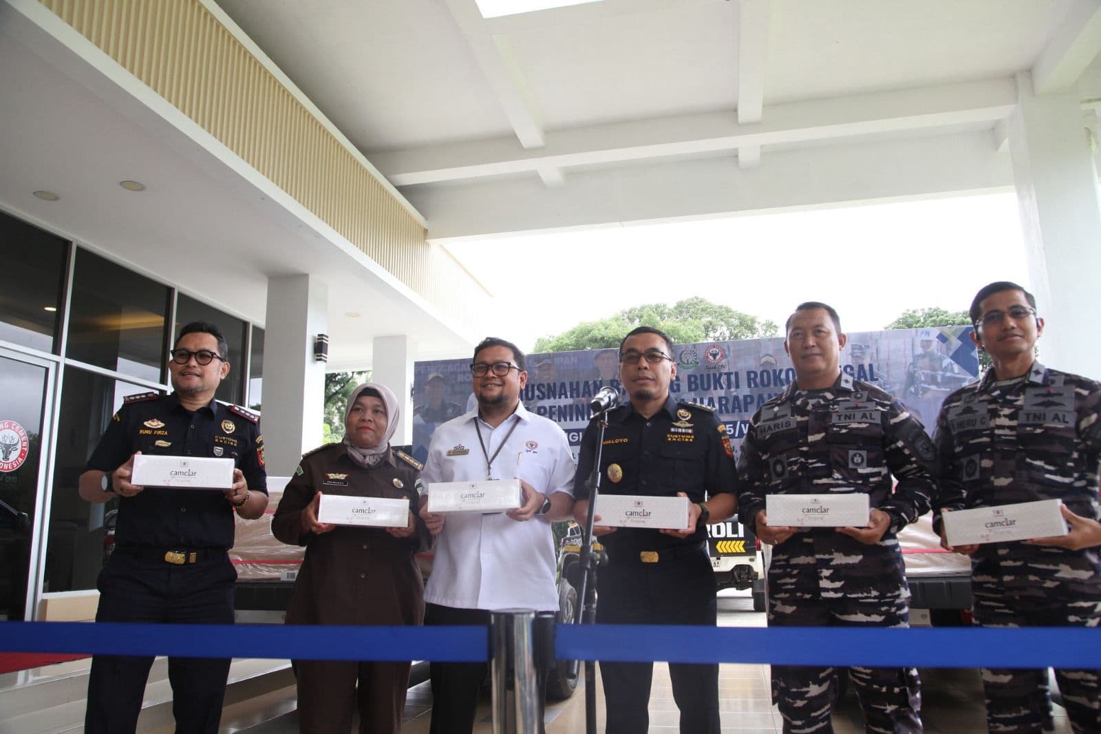 Riau customs officers destroying seized illegal cigarettes