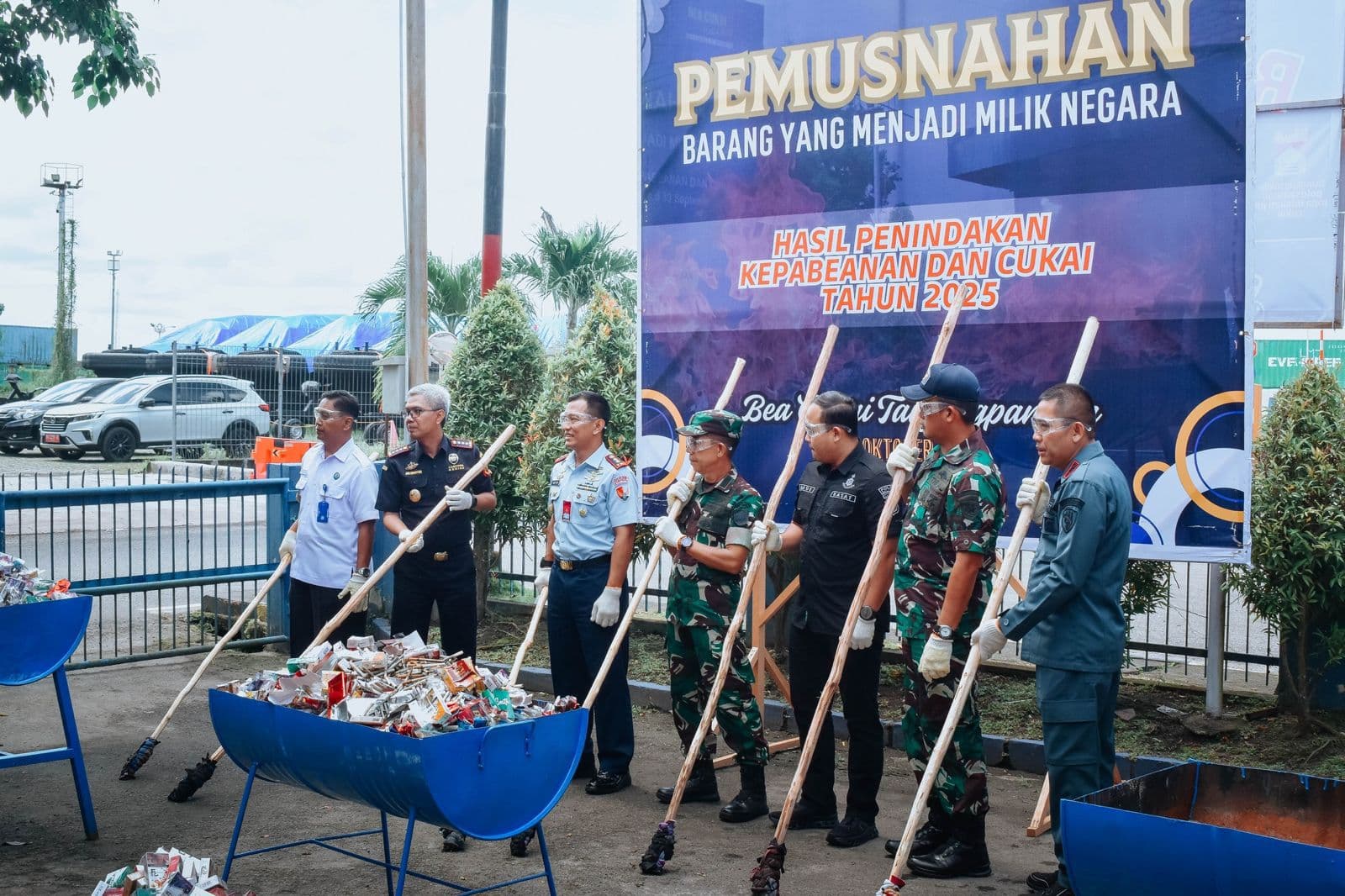 Customs officers burning seized illegal cigarettes and alcoholic drinks in Tanjungpandan